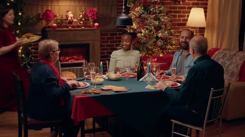 Family Celebrates Christmas Dinner Together at Home