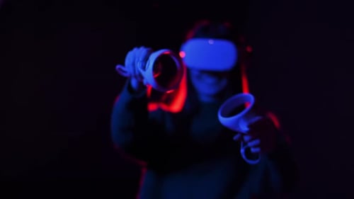 Woman Using Virtual Reality Headset and Controllers