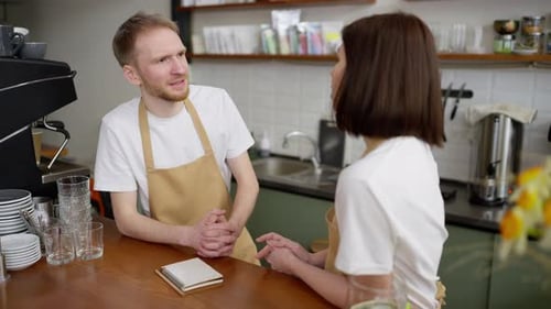 Cafe Employees Talking at the Counter