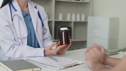 Female doctor is explaining and advising about using pills medicine and treatment to patient.
