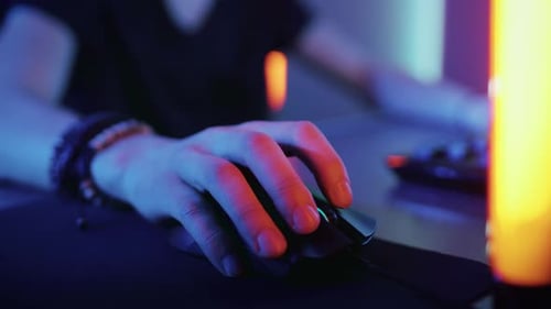 Close-up on the Hand that Uses Computer Mouse. Cool Neon Retro Lights. Browsing in Internet or Play