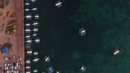 Aerial drone view of Coron Port, capturing the boats and vibrant coastal scenery.