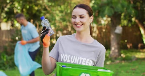 Happy Woman Volunteer Collecting Trash in Green Park
