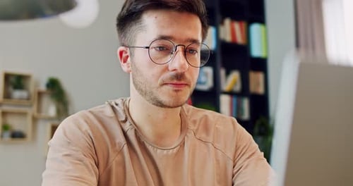 Young Adult Man Working on Laptop at Home