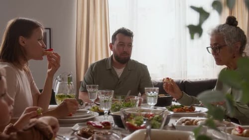 Family Together Enjoying Meal at Dining Room Table