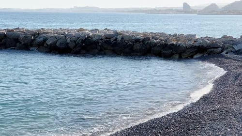 Azure Water Beats on a Pebble Beach at Sunset Sea Foam Sun Reflections on Water Not a Soul