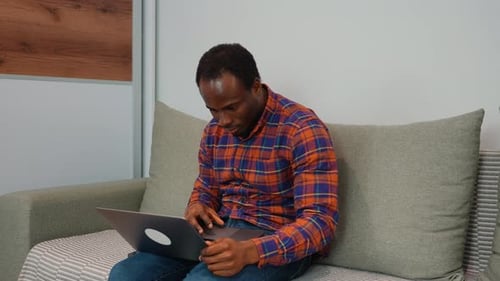African American Man Software Developer Programming Codes While Working From Home