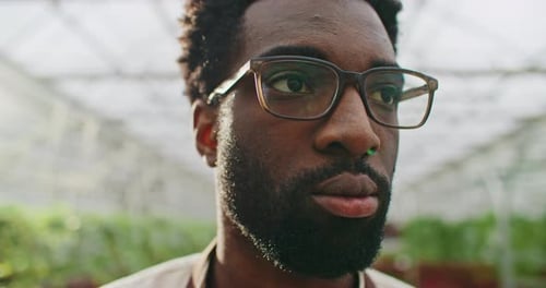 Very Close Facial View of Attractive African American Male Man Wearing Round Glasses for Better