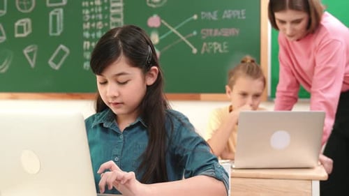 Smart asian girl looking at camera while coding engineering prompt. Pedagogy.