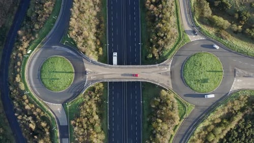 Sparse vehicle traffic at two interchange roundabouts over freeway