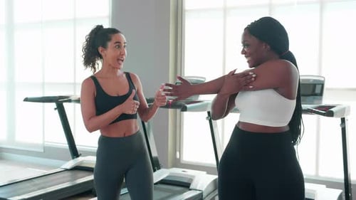 Coach or instructor training woman workout with warm up and stretch muscle arm in fitness gym.