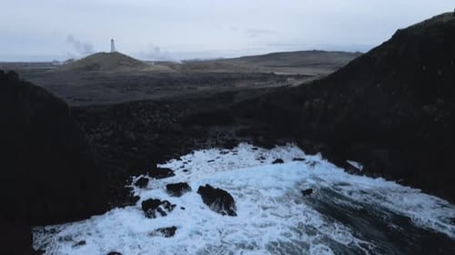 Aerial Seascape South Coast of Iceland. Waves Crashing to Black Rocks on Shore