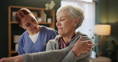 Senior Woman Doing Arm Stretches with Assistant