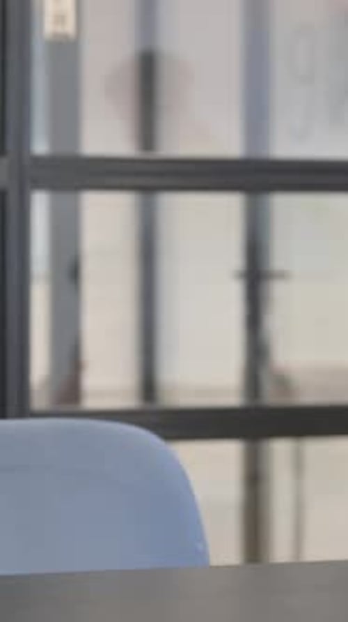 Adult Woman Sits at Table Indoors