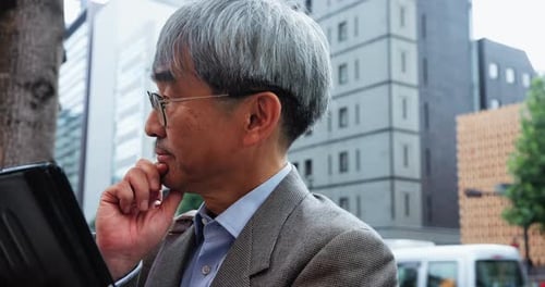 Mature businessman, thinking and tech in city for planning, brainstorming