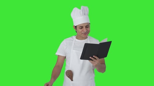 Indian professional chef making food with excitement Green screen