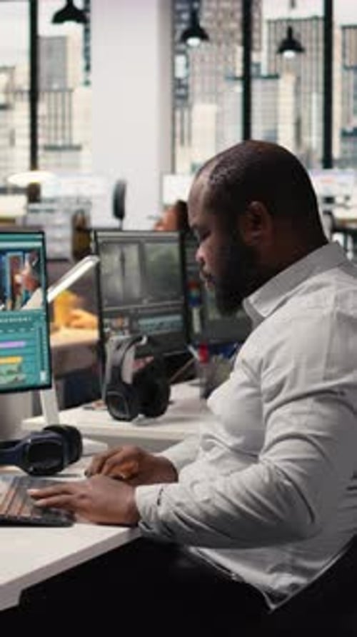 Man Video Editing in Modern Office Workspace