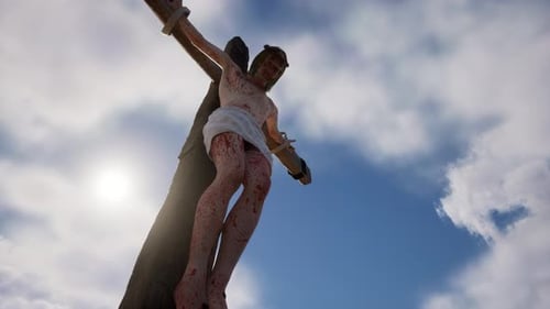 Dramatic Jesus Christ Crucifixion on Cross Against Blue Sky