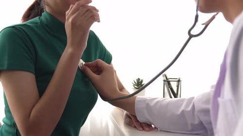 Doctor with stethoscope to check patients's pulse or body in hospital. Rigid.