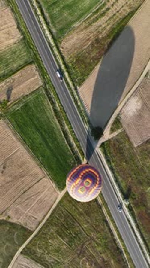 Vertical Video Hot Air Balloons Fly Over the Mountainous Landscape of Cappadocia Turkey