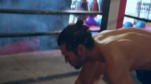 Boxer Punches Opponent in Ring, Man Falls to Ground