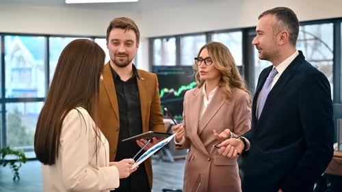 Business meeting in an office, workers discussing business affairs using papers with charts and gadg