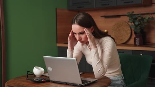 Stressed Woman Working at Home on Laptop