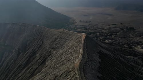 Man Walking Cliff Volcano Crater Bromo Drone Shot