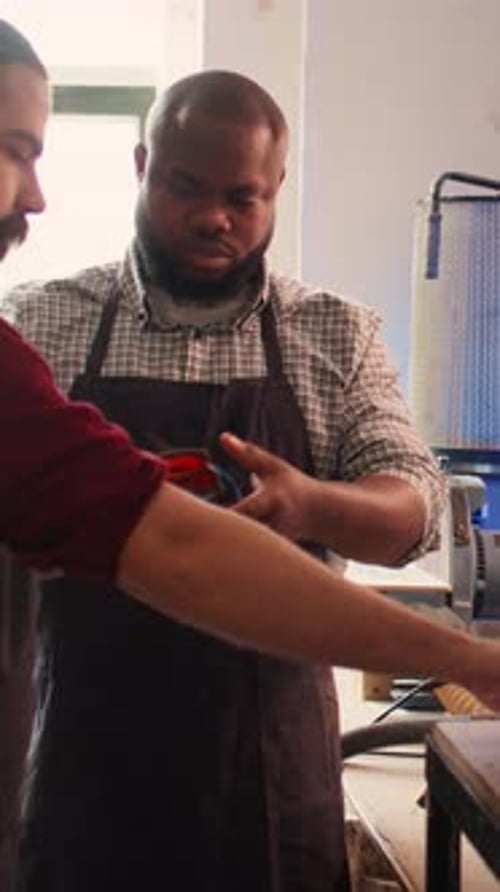 Vertical Video Master in Woodworking Shop Giving Worker Protection Gloves