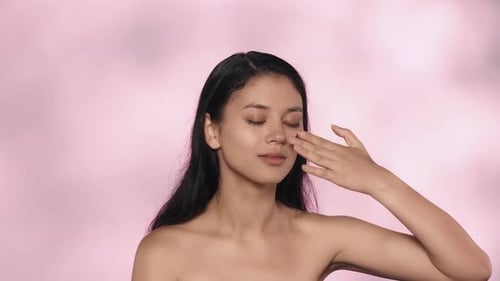 Closeup Studio Shot of Beautiful Female Model Brunette Girl Applying Gel Face Mask on Her Face Slow