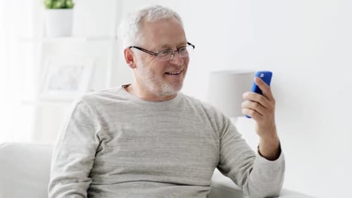 Smiling Senior Man Waving During Video Call