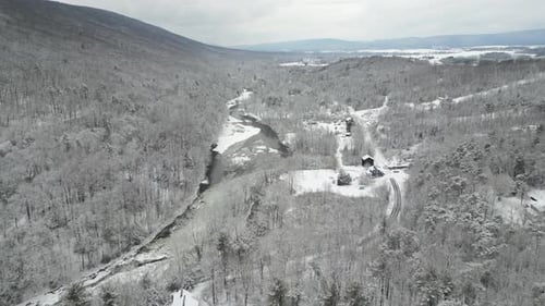 Breathtaking Aerial View of Snow-Covered Mountain Peaks and Winter Forest