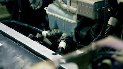 Closeup At Service Station an Oil Tank with Tubes Installed in the Car
