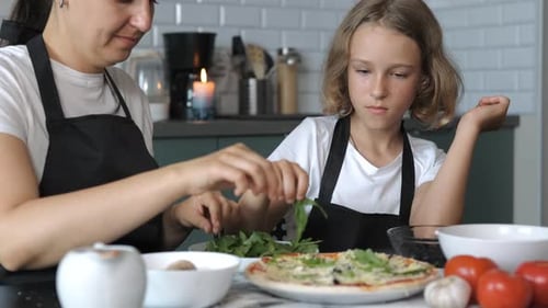 Woman and Child Prepare Pizza in Kitchen