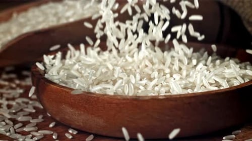 Rice is Poured Into a Wooden Bowl Filmed on a Highspeed Camera at 1000 Fps
