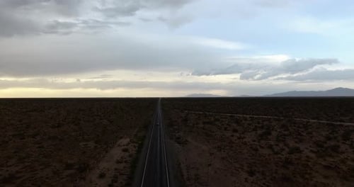 Aerial view of an endless road in the middle of the vast desert.