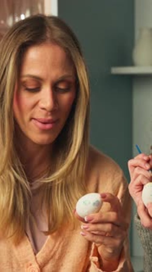 Close Up of Woman Painting Decorative Easter Egg