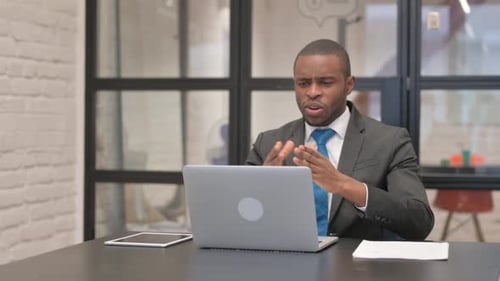 Professional Video Call on Laptop in Urban Office