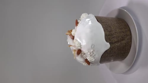 Vertical Video Easter Cake on a White Background Covered with Icing Almonds and Decorations