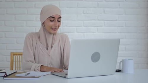 Woman on Video Call Working on Laptop