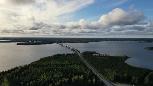 Finland autumn landscape with forest and bridge over lake, aerial view