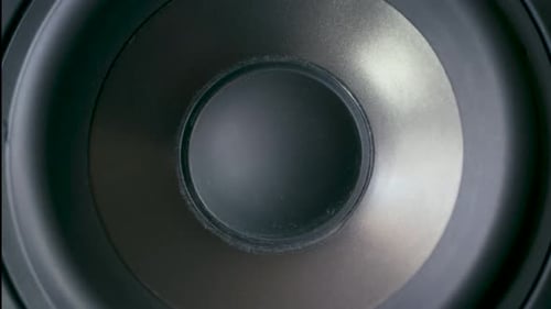 Speaker cone in out pumping from bass sound. Vibrating speaker, changing lights, close up, macro, fr