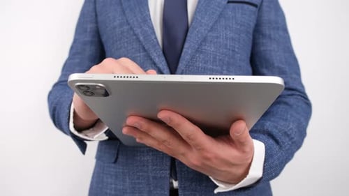 Man in Suit Using Silver Tablet Device
