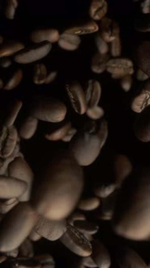 Coffee Beans Over Black Background. Close-up of coffee seeds. Super Slow Motion. 3d animation, 4K