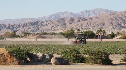 Tractor plow agricultural field in Coachella Valley, Indio, California