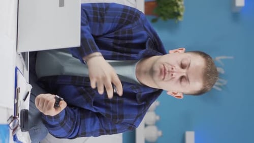 Vertical video of Home office worker sprays perfume on man.