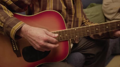 Senior Man Playing Guitar for Senior Woman
