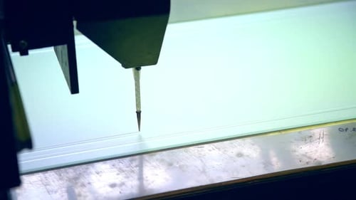 Modern equipment at the factory producing doors. Machine-tool applying picture on the glass.