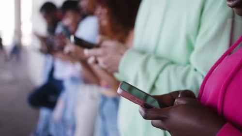 Diverse Group Uses Smartphones Together, Close Up Shot