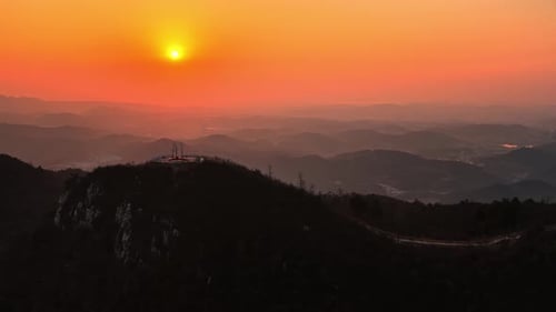 Scenic Mountain Range Under Orange Sky at Sunrise